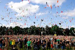 A lively crowd enjoying a colorful juggling event outdoors. Perfect for summer festival themes.